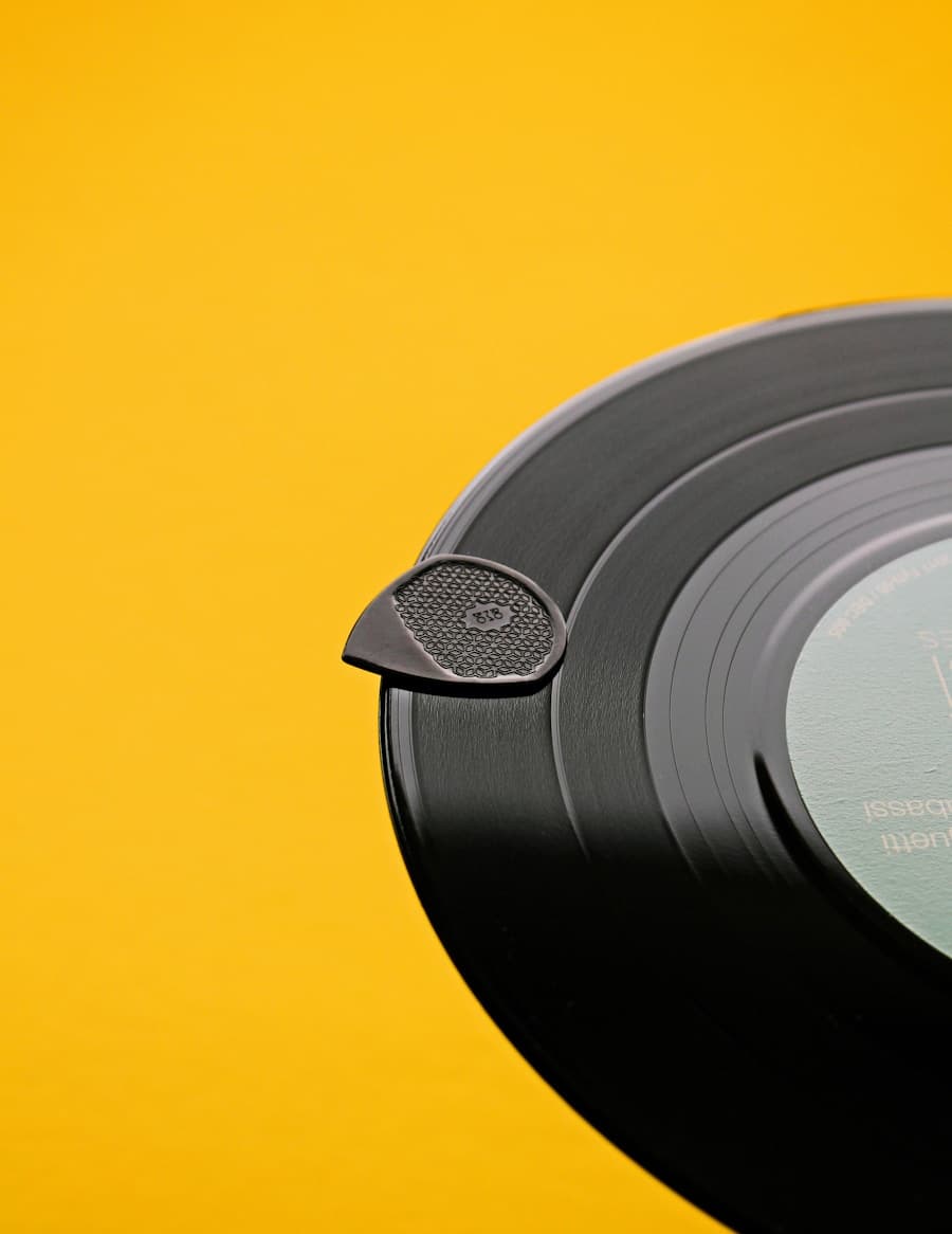 A black vinyl record on a vibrant yellow background